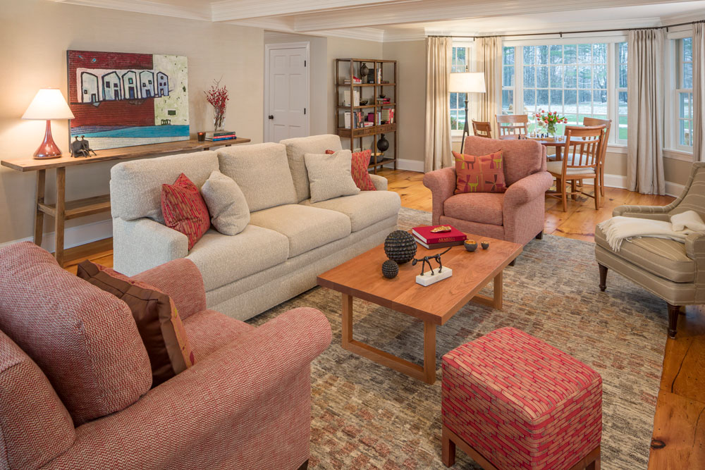 large sitting room with a dining table in the background